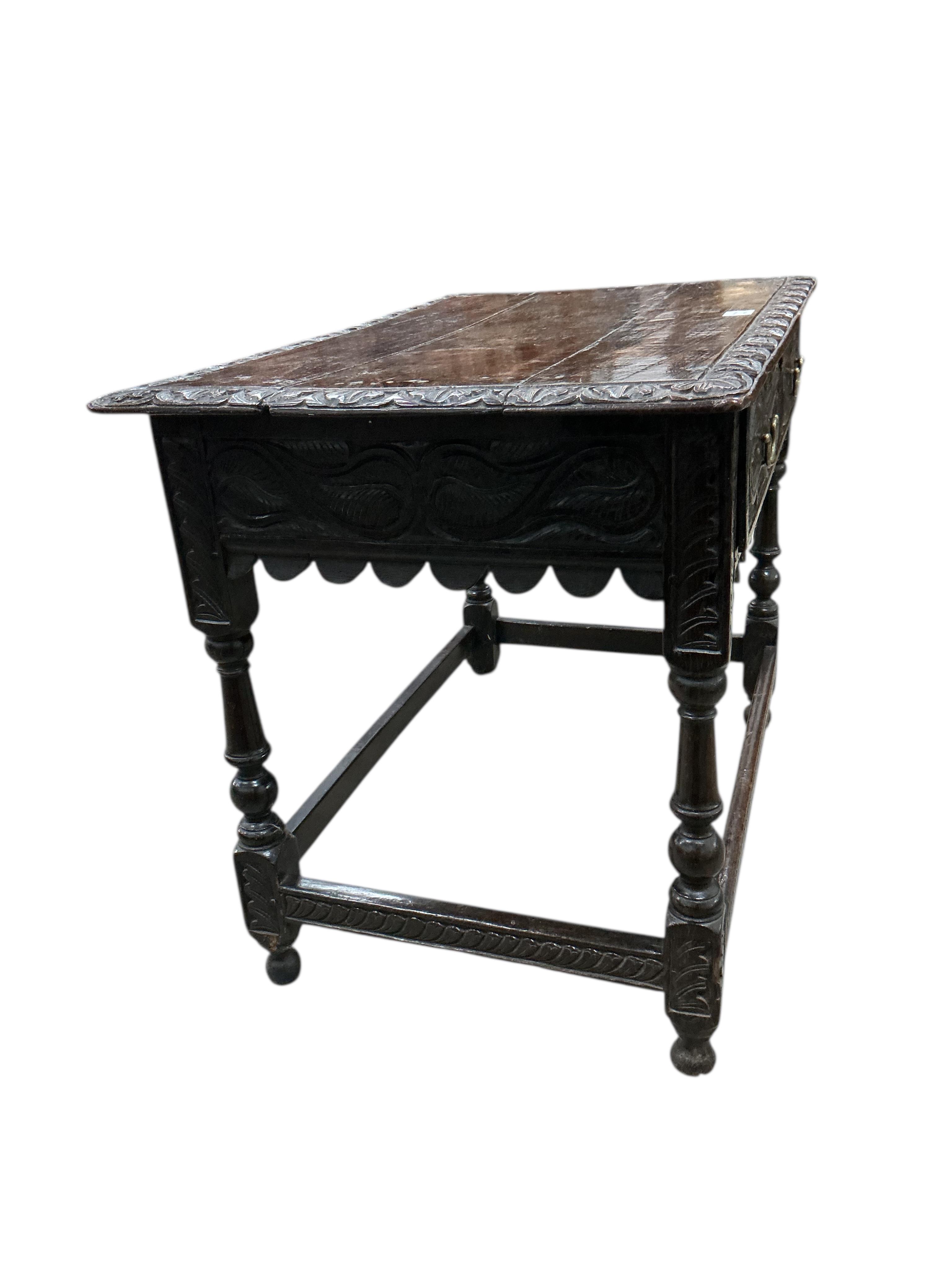 An early 18th century oak side table, later carved, width 99cm, depth 60cm, height 74cm